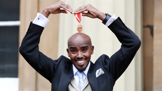 Mo Farah poses after he received his knighthood from Britain's Queen Elizabeth at Buckingham Palace, London