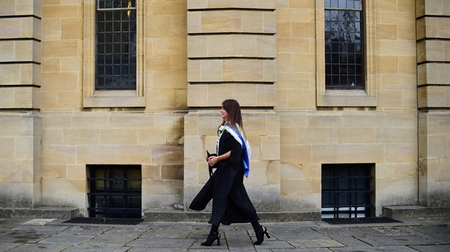 A graduate walks away after a graduation ceremony at Oxford University, in Oxford, Britain July 15, 2017.