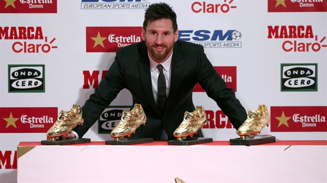 Barcelona's Lionel Messi poses with his four Golden Boot trophies during a ceremony in Barcelona