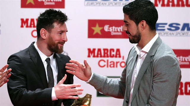 Barcelona's Lionel Messi is congratulated as he receives his fourth Golden Boot trophy from Luis Suarez during a ceremony in Barcelona