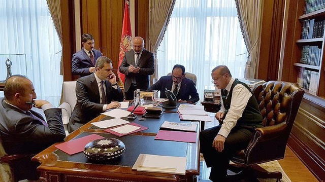 Turkish President Recep Tayyip Erdogan (R) appears while talking to US President Donald Trump over the phone while Presidential spokesman Ibrahim Kalin (CR), Chief of Turkish Intelligence Agency Hakan Fidan (CL) and Foreign Minister Mevlut Cavusoglu (L) join him.