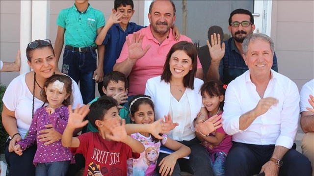 Turkish teacher Saadet Özkan (C) known for her work to protect children from abuse, poses with children in southern Hatay province