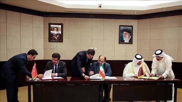 Turkish Minister of Economy, Nihat Zeybekci (2nd L), Qatar’s Minister of Economy and Commerce Sheikh Ahmed bin Jassim bin Mohammed Al Thani (2nd R) and Iranian Minister of Industry, Mine and Trade Mohammad Shariatmadari (C) sign an agreement to ease transportation and transit passages of trade goods between Turkey-Iran-Qatar during the 26th session of Iran-Turkey Joint Economic Commission in Tehran, Iran on November 26, 2017. 