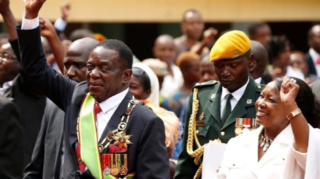Zimbabwe's new president Emmerson Mnangagwa and his wife Auxillia wave to their suppoters as they leave after the swearing in ceremony in Harare, Zimbabwe
