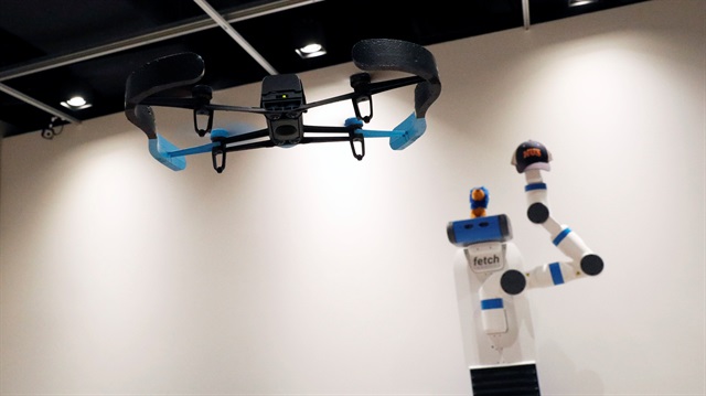 A drone takes photos of a robot during a demonstration of Xpose, an interactive drone photo-taking system, at the NUS School of Computing faculty premises in Singapore.