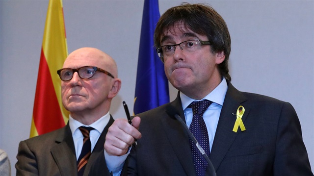 Ousted Catalan leader Carles Puigdemont and his lawyer Paul Bekaert take part in a news conference in Brussels