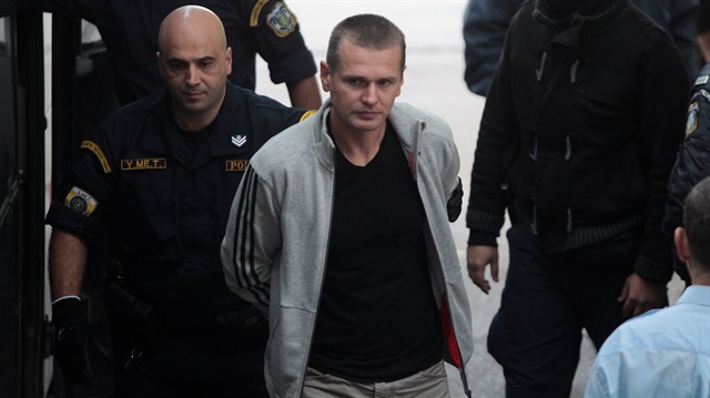 Alexander Vinnik, a 38 year old Russian man (C) suspected of running a money laundering operation using bitcoin, is escorted by police officers to a court in Thessaloniki, Greece.