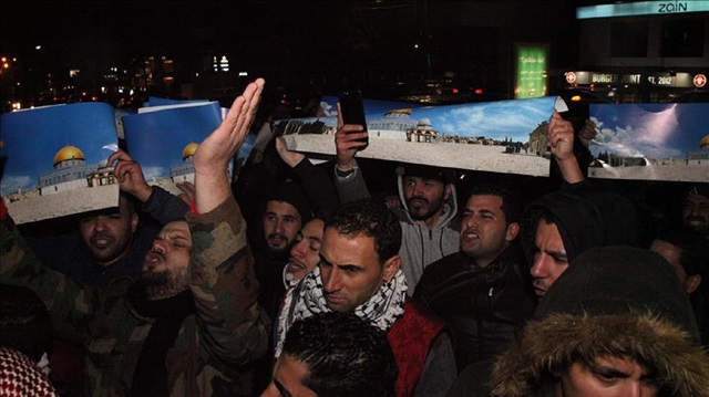 People hold placards during a protest against the US President Donald Trump’s recognition of Jerusalem as Israel’s capital, in front of Israeli Embassy in Amman, Jordan on December 06, 2017.