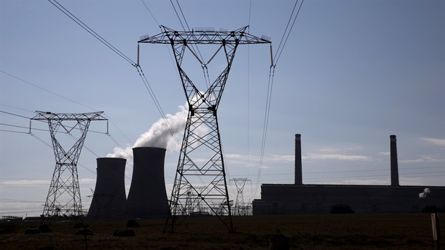 File Photo: Electricity pylons are seen near the cooling towers of a power station owned by state power utility ESKOM, near Middelburg, South Africa