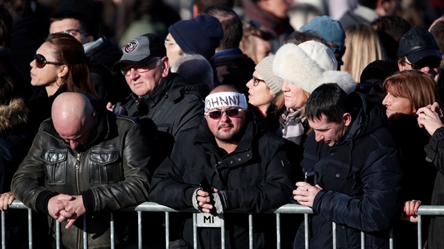 Fans react during a 'popular tribute' to late French singer and actor Johnny Hallyday in Paris