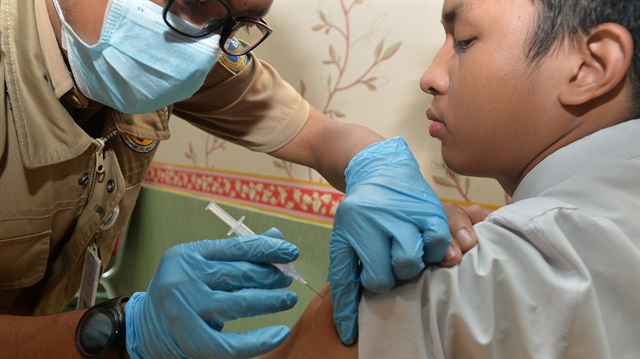 A high-school student receives a diphtheria vaccination at an Outbreak Response Immunization (ORI) clinic as health authorites try to contain a sharp rise in cases of diphtheria in Cengkareng, Jakarta