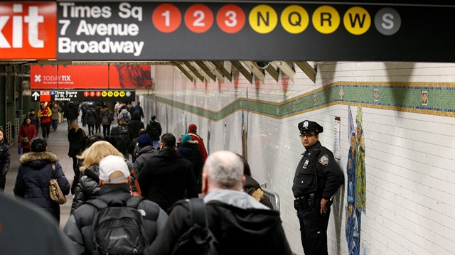 A New York City Police (NYPD) officer stands in the subway corridor