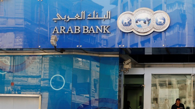 People walk in front of Arab Bank in downtown Cairo, Egypt 