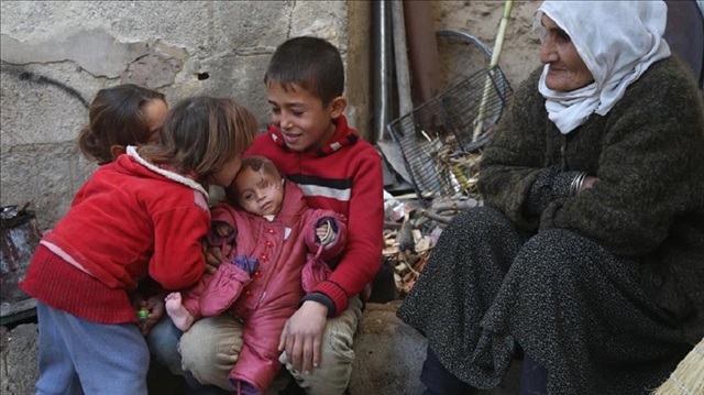 A Syrian baby Kerim, who lost his left eye and his mother after Assad regime's attack on Hammuriye district, is seen with wounds on his head in besieged Damascus suburb of Eastern Ghouta, Syria on December 15, 2017. A Syrian baby, try to hold on to life with his young age brother and sisters. 