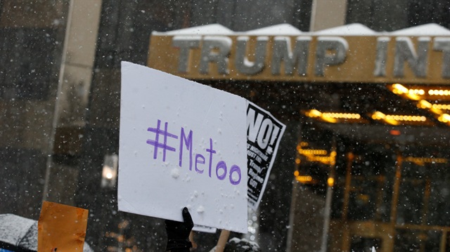 Protest signs are raised at #MeToo demonstration outside Trump International hotel in New York