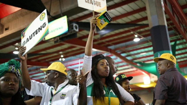 ANC members hold placards at the 54th National Conference of the ruling African National Congress (ANC) at the Nasrec Expo Centre in Johannesburg, South Africa