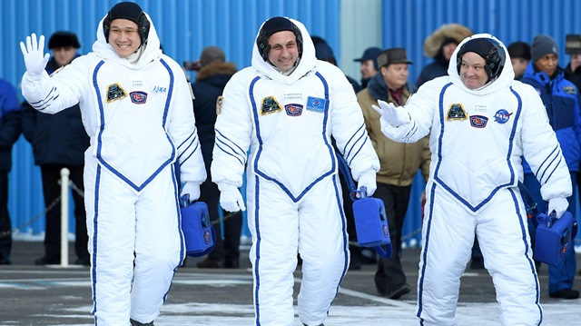Members of the International Space Station expedition 54/55, Roscosmos cosmonaut Anton Shkaplerov (C), NASA astronaut Scott Tingle (R) and Norishige Kanai (L) of the Japan Aerospace Exploration Agency (JAXA) during the send-off ceremony after checking their space suits before the launch of the Soyuz MS-07 spacecraft at the Baikonur cosmodrome, in Kazakhstan, 17 December 2017. 