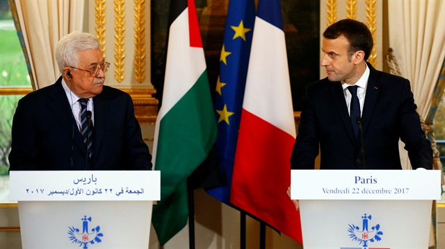 French President Emmanuel Macron (R) and Palestinian President Mahmoud Abbas deliver a press statement after a meeting at the Elysee Palace in Paris, France, December 22, 2017.