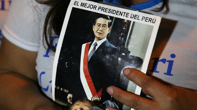 A supporter holds a portrait of former President Alberto Fujimori after Peruvian President Pedro Pablo Kuczynski pardoned Fujimori who was serving a 25-year prison sentence, outside Centenario hospital in Lima, Peru, December 24, 2017.