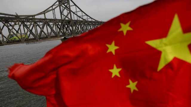 File Photo: A Chinese flag is seen in front of the Friendship bridge over the Yalu River connecting the North Korean town of Sinuiju and Dandong in China's Liaoning Province