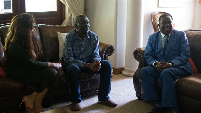 Zimbabwean President Emmerson Mnangagwa chats during his visit to opposition leader Morgan Tsvangirai and his wife, Elizabeth, at his house in Harare