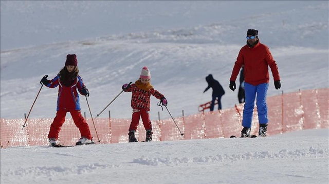 People skiing at the Saklikent Ski Resort above Beydaglari Mountains that is offering an opportunity of 5 kilometers of uninterrupted skiing and snowboarding also with its' 1,500 people transport capacity chair-lifts per hour, during winter season in Antalya province of Turkey