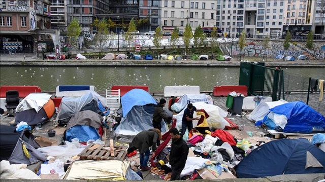 Migrants set up temporary shelter tents near the Canal Saint-Martin, Jaures and Stalingrad metro stations in northern Paris