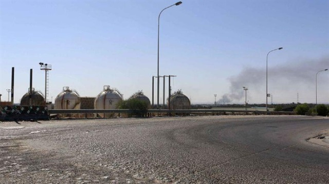 File Photo: Smoke rises near oil tanks after heavy fighting between rival militias broke out near the airport in Tripoli.
