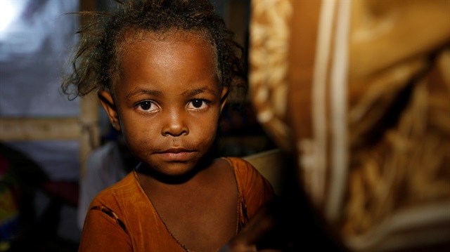 A girl whose family was displaced by the war in the northwestern areas of Yemen is pictured in her family's makeshift hut on a street in the Red Sea port city of Hodeida