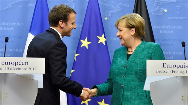 File Photo: French President Macron and German Chancellor Merkel shake hands after a joint news conference in Brussels