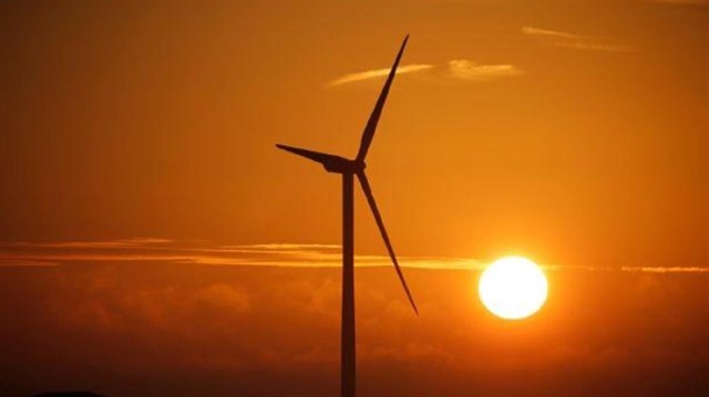 File Photo: A power-generating windmill turbine is pictured during sunrise at a wind park in Escarmain near Cambrai, France, August 9, 2017