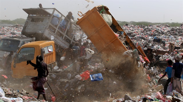 People collect recyclables and food at a garbage dump near the Red Sea port city of Hodeidah