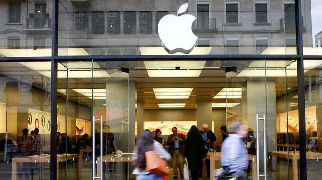 FILE PHOTO: People walk in front of a branch of U.S. technology company Apple
