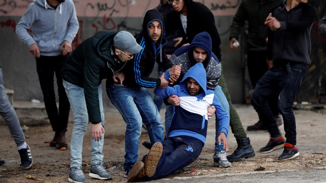 Wounded Palestinian is evacuated during clashes with Israeli troops in the West Bank city of Jenin