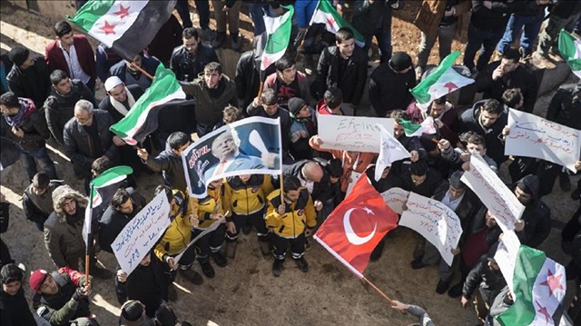 People hold placards during a protest against terrorist organizations PKK/PYD, appealing for help of Turkish Army and The Free Syrian Army with the clearance of Afrin district, in Azaz district of Aleppo, Syria on January 19, 2018. ( Emin Sansar - Anadolu Agency )