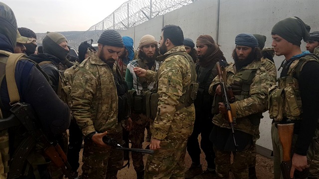 Free Syrian Army (FSA) Commander Ebu Meryem (front) and other FSA members move towards Afrin as part of the "Operation Olive Branch" in Syria on January 21, 2018. 