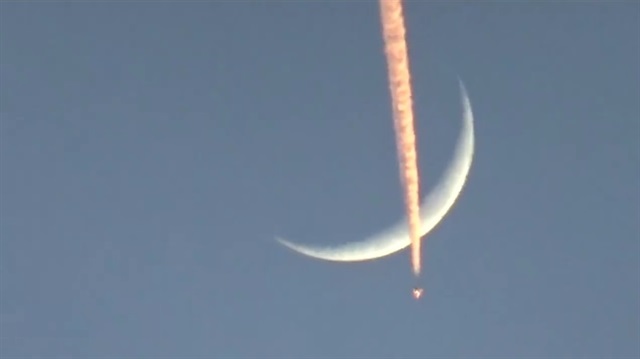 A photo taken from Turkey's Hatay shows a Turkish military aircraft contrails the moon as it flies within the 'Operation Olive Branch' launched in Syria's Afrin, on January 20, 2018 in Hatay, Turkey.
