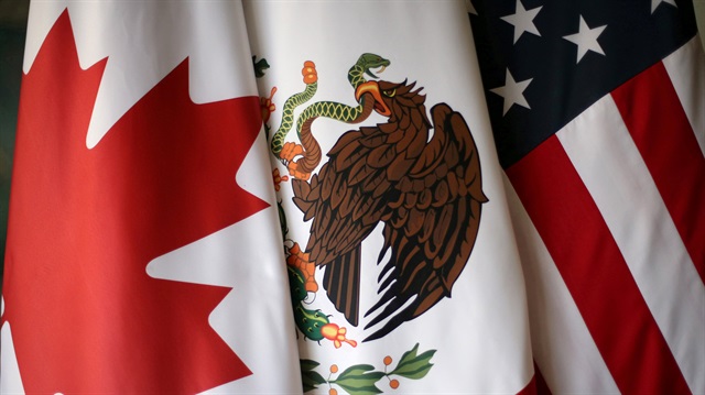 Flags are pictured during the fifth round of NAFTA talks involving the United States, Mexico and Canada, in Mexico City, Mexico, November 19, 2017. REUTERS/Edgard Garrido/File Photo