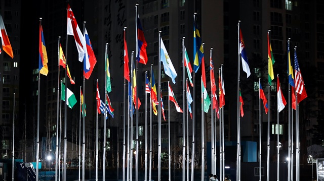 Participating national flags flutter in the wind at the the Olympic Village in Gangneung