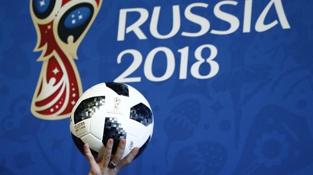 presenter holds the official match ball for the 2018 FIFA World Cup Russia