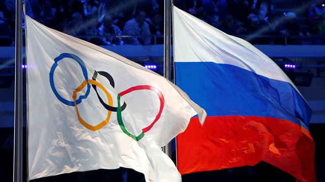 File Photo: Russian national flag and Olympic flag are seen during closing ceremony for 2014 Sochi Winter Olympics