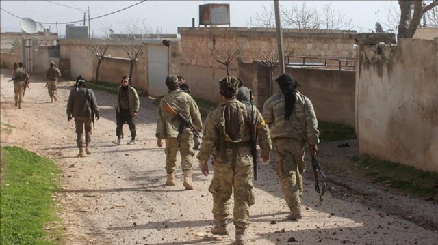 Members of Free Syrian Army (FSA) patrol after Turkish Armed Forces and FSA liberated the village of Deir Ballut in Jandaris, western Afrin from all PYD/PKK terrorists within 'Operation Olive Branch' to Syria's Afrin on February 10, 2018.