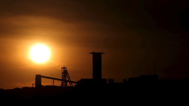 File Photo: The sun sets behind a shaft outside the mining town of Carletonville, west of Johannesburg, July 7 2015