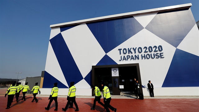 Security personnel pass by the Tokyo 2020 Japan House during a media preview in Gangneung