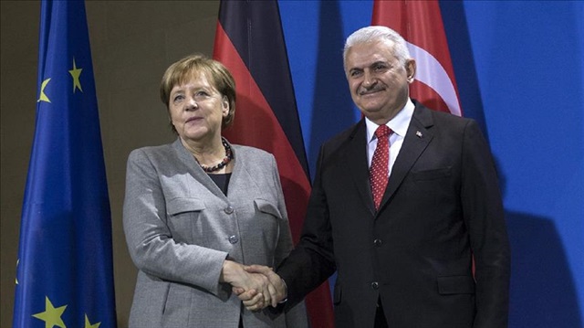Turkish Prime Minister Binali Yildirim (R) poses for a photo with German Chancellor Angela Merkel (L) after a press conference in Berlin, Germany on February 15, 2018. 