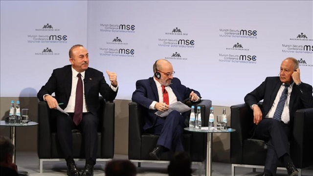 Turkish Foreign Minister Mevlüt Çavuşoğlu (L) speaks as he attends the "Enlargement of Gulf" discussion platform on the sidelines of 'Munich Security Conference' in Munich, Germany on February 18, 2018.
