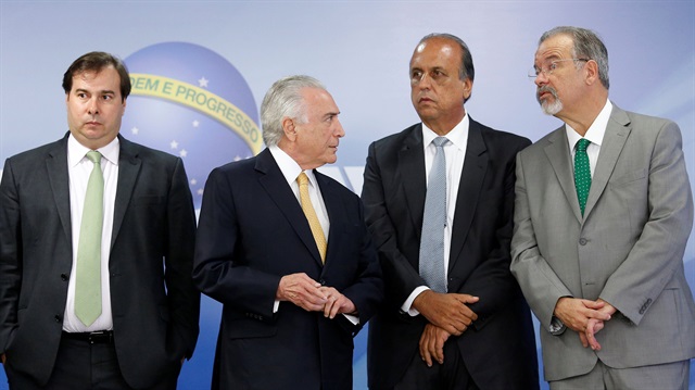 Brazil's President Michel Temer (2nd L), Rio de Janeiro's governor Luiz Fernando Pezao (2nd R), Defense Minister Raul Jungmann (R), and Chamber of Deputies President Rodrigo Maia are seen after the announcement of the decree of the army to take over command of police forces in Rio de Janeiro state, at Planalto Palace in Brasilia, Brazil February 16, 2018