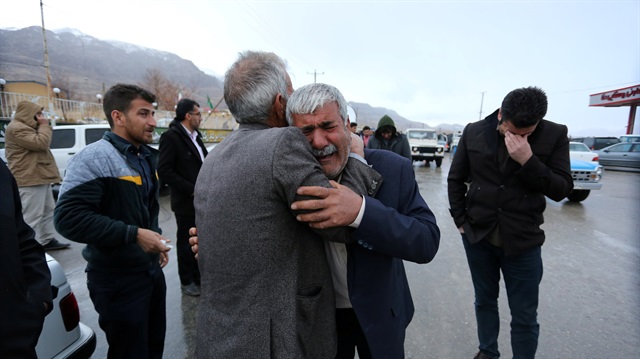 Relatives of passengers who were believed to have been killed in a plane crash react near the town of Semirom