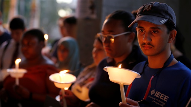 Participants hold candles for victims of the shooting in Parkland, Florida