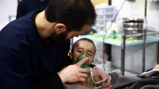 Man with a child are seen in hospital in the besieged town of Douma, Eastern Ghouta